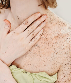 Woman applying body scrub for pre tan prep